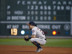 Houston Astros second baseman Jose Altuve pauses during the seventh inning when the Boston Red Sox scored six runs in Game 3 of baseball's American League Division Series, Sunday, Oct. 8, 2017, in Boston.