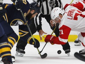 Buffalo Sabres Ryan O'Reilly, left, and Detroit Red Wings Dylan Larkin take the face-off during the first period of an NHL hockey game on Oct. 24, 2017, in Buffalo, N.Y.