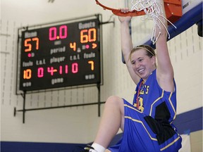 St. Anne's Brittany Hedderson hangs from the hoop while cutting off the net after her team won the OFSAA girls' AAAA basketball championship at St. Anne high school in 2007.