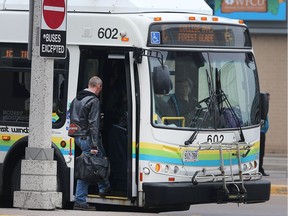 A Transit Windsor bus driver picks up a passenger on Oct. 12, 2017, in the city's downtown area. The organization plans on hiring 16 new drivers.