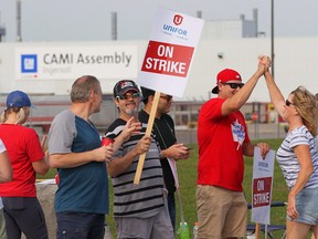 Employees of the GM CAMI assembly factory stand on the picket line in Ingersoll, Ont., before the strike ended this week.