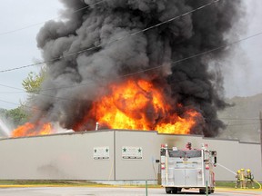 Fire crews battle flames and toxic black smoke in downtown Chatham Saturday afternoon.