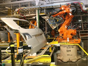 One of over a thousand robots at the Chrysler Windsor Assembly Plant handles parts for the Dodge Grand Caravan.
