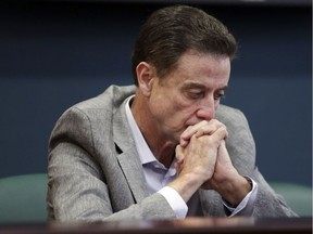 In this June 15, 2017, photo, Louisville basketball coach Rick Pitino listens during an NCAA college basketball news conference in Louisville, Ky. Louisville's Athletic Association officially fired coach Rick Pitino on Oct. 16, 2017, nearly three weeks after the school acknowledged that its men's basketball program is being investigated as part of a federal corruption probe.