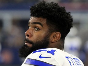 In this Oct. 12, 2017, photo, Dallas Cowboys' Ezekiel Elliott stands on the sideline in the first half of a preseason NFL football game against the Indianapolis Colts in Arlington, Texas. A federal appeals court on Oct. 12, 2017, lifted an injunction that blocked a six-game suspension for  Elliott, clearing the way for the NFL's punishment over domestic violence allegations and likely leading to the running back's legal team seeking further relief.