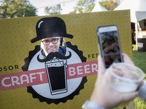 Sherry McCauley takes a photo of Mark Sanford at the Windsor Craft Beer Festival at Willistead Park, Friday, Oct. 13, 2017.