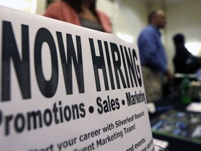 A sign attracts job-seekers during a job fair at the Marriott Hotel in Colonie, N.Y.