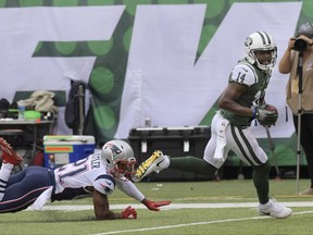 New York Jets wide receiver Jeremy Kerley, right, runs away from New England Patriots' Malcolm Butler (21) for a touchdown during the first half of an NFL football game Sunday, Oct. 15, 2017, in East Rutherford, N.J. (AP Photo/Bill Kostroun)