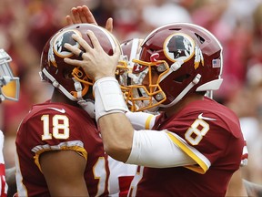 Washington Redskins quarterback Kirk Cousins (8) congratulates wide receiver Josh Doctson (18) after a touchdown during the first half of an NFL football game against the San Francisco 49ers in Landover, Md., Sunday, Oct. 15, 2017. (AP Photo/Alex Brandon)