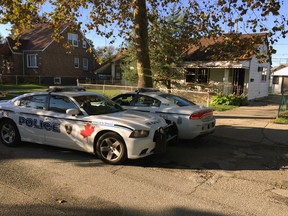 Windsor Police keep an eye on a home in the 1700 block of Cadillac Street in Windsor on Oct. 17, 2017.