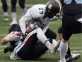 Dante Fornesario, top, of the Windsor AKO Fratmen tackles Emmet Putt of the Hamilton Hurricanes during Sunday's Ontario Football Conference final at the University of Windsor's Alumni Stadium.
