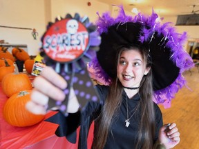 Mara Tersigni, a co-op student with Ford City Renewal, holds up a scariest costume award that to be handed out Thursday night during the Ford City Haunted Market hosted by the Residents in  Action and the Heimat Centre at 1367 Drouillard Rd.