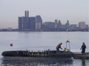 Workers remove the cable from the Peace Fountain before it's taken away for the winter. The fountain adjacent to Coventry Gardens on the Detroit River operates between May and October each year, shooting water as high as 70 feet with a dazzling light display at night.