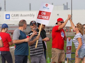 Employees of the GM CAMI assembly factory stand on the picket line in Ingersoll, Ont., on Monday, Sept. 18, 2017.