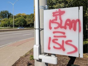 Racist and anti-Islamic graffiti appeared at several locations across Windsor on the weekend. An angry Jon Liedtke, who learned of the graffiti on social media, grabbed paint and brush and covered the signs, including this one on a hydro box on Huron Church Road.