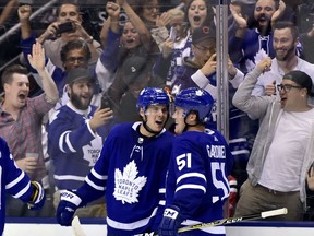 Toronto Maple Leafs centre Auston Matthews (34) celebrates his game-winning goal with teammate Jake Gardiner (51) during overtime NHL hockey action against the Chicago Blackhawks, in Toronto on Oct. 9, 2017.