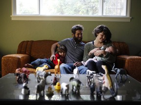 Laura Pine with her husband Damien and their daughters Aren, 2, and two-month old Jacqueline are photographed at their home in Cowichan Bay, B.C., on Sunday, October 1, 2017. Laura Pieterson and Damien Boisvert Neufeld decided to bestow their two children with the invented surname Pine, an homage to the fact they met while tree-planting and continue to work in silviculture.