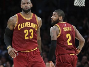 In this March 19, 2017, photo, Cleveland Cavaliers' LeBron James, left, greets Kyrie Irving during the second half of an NBA basketball game against the Los Angeles Lakers in Los Angeles. Irving was traded to the Boston Celtics and returns to Cleveland to play against the Cavaliers, on Oct. 17.