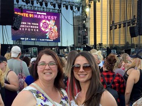 Valerie Whitney, left, and Sarah Batal stand near the stage at the Route 91 Harvest concert in Las Vegas on Sunday. The photo was taken before shots rained down on the crowd from the nearby Mandalay Bay Hotel.