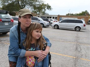 Tara Varga and her daughter, Brenna, are shown in front of St. André French Immersion Catholic Elementary School in Tecumseh on Oct. 10, 2017. Tara Varga, chair of school's parents' council, is upset that drinking water tests for lead contamination required for all Ontario schools revealed St. André has high lead levels but parents were not informed.