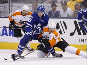 Maple Leafs forward Mitch Marner has the puck knocked away by Flyers defenceman Travis Sanheim at the Air Canada Centre on Oct. 26, 2017. (Mike Peake/Postmedia)