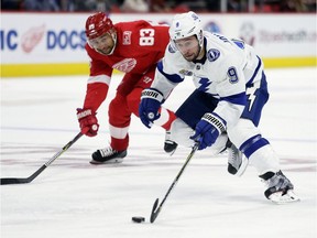 Tampa Bay's Tyler Johnson drives down the ice past Detroit defenceman Trevor Daley  for an unassisted goal during the first period of an NHL hockey game on Oct. 16, 2017, in Detroit.