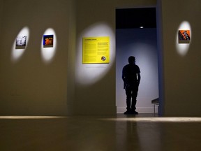 In a Friday, Sept. 15, 2017 photo, Kendall College of Art and Design student, Samuel Lee, stands near John Naccarato's ArtPrize entry "DAY for NIGHT" at The Fed Galleries @ KCAD, Kendall College of Art and Design, in Grand Rapids, Mich. ArtPrize Nine starts Wednesday in Grand Rapids and runs through Oct. 8.