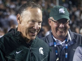 Michigan State head coach Mark Dantonio, left, celebrates with athletic director Mark Hollis, right, after the Spartans defeated Michigan 14-10 in an NCAA college football game in Ann Arbor, Mich., on Oct. 7, 2017. Michigan State returned to the Top 25 faster than many people expected. After beating Michigan last weekend, the No. 21 Spartans suddenly have to deal with something that's been mostly absent for the past year, expectations.