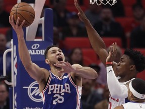 Philadelphia 76ers guard Ben Simmons shoots as Detroit Pistons forward Stanley Johnson, right, defends during the first half of an NBA basketball game, Oct. 23, 2017, in Detroit.