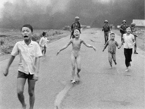 FILE - This is a  June 8, 1972 file photo of South Vietnamese forces follow after terrified children, including 9-year-old Kim Phuc, center, as they run down Route 1 near Trang Bang after an aerial napalm attack on suspected Viet Cong hiding places .