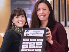 Kim Badour, left, and Danielle Ray — both nurses in the oncology department at the Windsor Regional Hospital Met Campus — pose with the Daniel Johnson Memorial Education Nurses Award after a ceremony on Friday. The award recognizes the exemplary and compassionate work that the nurses do caring for cancer patients.
