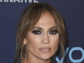 FILE - In this Sept. 18, 2017 file photo, Jennifer Lopez arrives at the "World of Dance" Celebration in West Hollywood, Calif. Lopez released a statement Tuesday saying she is postponing her "Jennifer Lopez: All I Have" concert appearances out of respect to the victims of Sunday's shooting. The statement says performances set for Wednesday, Friday and Saturday will be rescheduled and that tickets will be refunded or replaced. (Photo by Jordan Strauss/Invision/AP, File)
