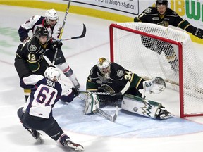 The Windsor Spitfires' Luke Boka shoots on London Knights' goaltender Tyler Johnson during first-period action at the WFCU Centre on Thursday. Windsor won the game 3-1.