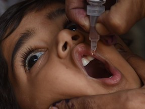 A Pakistani health worker administers polio drops to a child during a polio vaccination campaign in Karachi in January 2016.