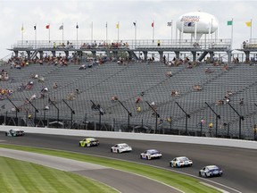 FILE - In this July 23, 2017, file photo, the field for the NASCAR Brickyard 400 auto race makes its way past fans in the stands in the first turn at Indianapolis Motor Speedway in Indianapolis. From tens of thousands of empty seats at the tracks to dwindling ratings for those watching at home, NASCAR has a popularity problem.  FILE PHOTO
Michael Conroy, AP