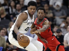 Toronto Raptors guard Kyle Lowry (7) reaches in on San Antonio Spurs forward Rudy Gay (22) during the first half of an NBA basketball game, Oct. 23, 2017, in San Antonio. San Antonio won 101-97.