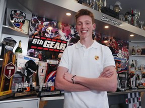 Roman De Angelis, 16, stands with an impressive wall of racing trophies and accolades in his Lakeshore home recently.