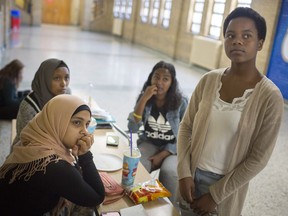 Grade 12 students at Kennedy Collegiate, clockwise from bottom left, Ruqaya Abed, Muna Taher, Rwan Galaleldin, and Esther Emode, discuss the pros and cons of starting classes later in the morning to accommodate tired students, on Oct. 18, 2017.