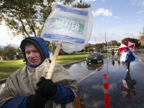 Chuck Fuerth walks the picket line with other members of faculty from St. Clair College at the main campus on Oct. 30, 2017.