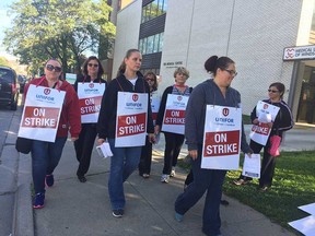 Lab assistants and lab technologists with strike placards at the Medical Laboratories of Windsor location at 1428 Ouellette Ave. on the morning of Oct. 2, 2017.