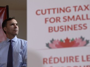 Finance Minister Bill Morneau looks on at a press conference on tax reforms in Stouffville Oct. 16, 2017.