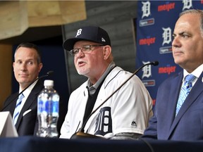 Detroit Tigers baseball team's new manager Ron Gardenhire wears a Tigers hat and jersey as he is flanked by Chris Ilitch, left, president and CEO of Ilitch Holdings, Inc., and Tigers general manager and executive vice president of baseball operations Al Avila, during an introductory press conference at Comerica Park in Detroit on Oct. 20, 2017.