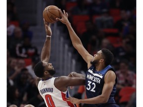 Minnesota Timberwolves centre Karl-Anthony Towns (32) blocks a shot by Detroit Pistons centre Andre Drummond (0) during the second half of an NBA basketball game on Oct. 25,2017, in Detroit.