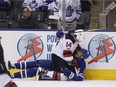 Adam Henrique and Toronto's Matt Martin mix it up as the Toronto Maple Leafs were beaten 6-3 by the New Jersey Devils at the Air Canada Canada Centre in Toronto on Oct. 11, 2017.