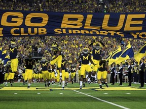 (file) The University of Michigan football team takes the a game against Notre Dame in Ann Arbor, Michigan.