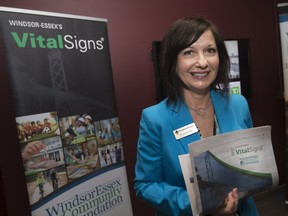 Lisa Kolody, executive director of WindsorEssex Community Foundation, holds the 2017 Vital Signs report to the community during a news conference at the Windsor Star News Cafe on Oct. 3, 2017.