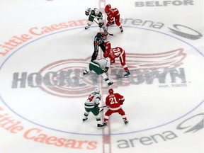 The puck drops for the Detroit Red Wings-Minnesota Wild NHL hockey game in the first period on Oct. 5, 2017, in Detroit. It was the first regular-season NHL game at Detroit's new Little Caesars Arena.