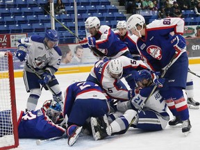 Players from the  Sudbury Wolves and the Windsor Spitfires pile up in front of the Spitfires' goalie Mikey DiPietro during Friday's OHL game at the Sudbury  Arena, which the Spitfires won 7-2.   John Lappa/Sudbury Star/Postmedia Network
John Lappa, John Lappa/Sudbury Star