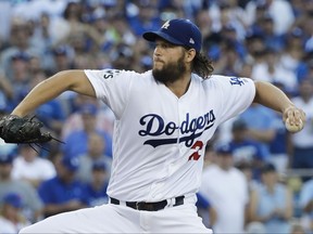 Los Angeles Dodgers starting pitcher Clayton Kershaw throws during the first inning of Game 1 of baseball's World Series against the Houston Astros on Oct. 24, 2017, in Los Angeles.