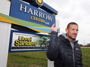 World-class triatlete Lionel Sanders stands next to a Harrow gateway sign bearing his name after an unveiling ceremony Wednesday.